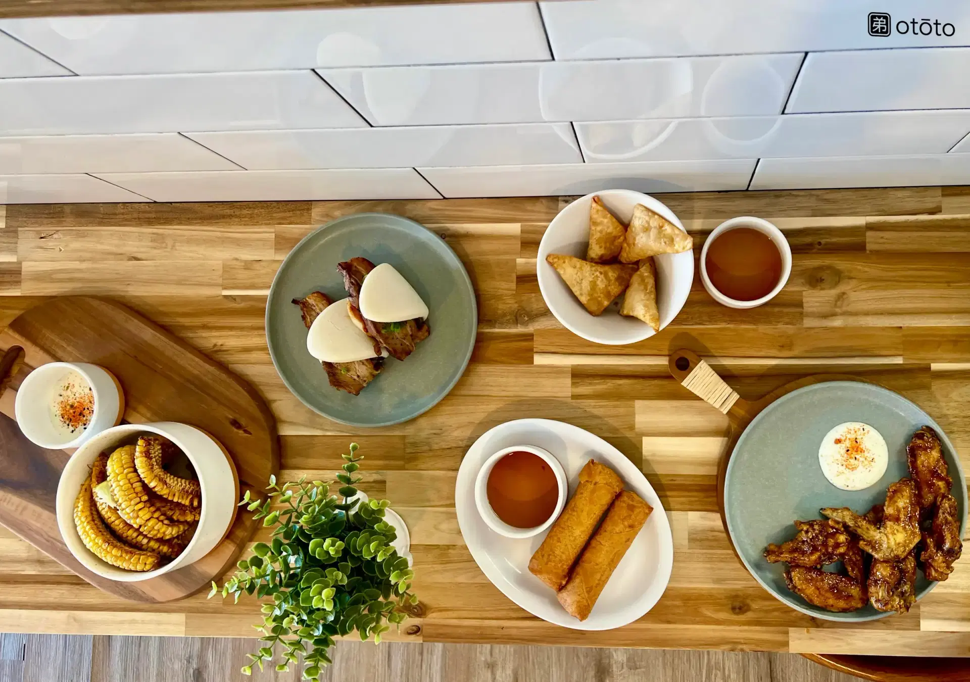 Spread of Ototo appetizers on a wooden table